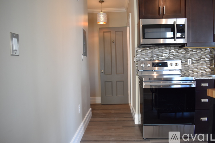 A kitchen with a stove top oven and microwave above it.