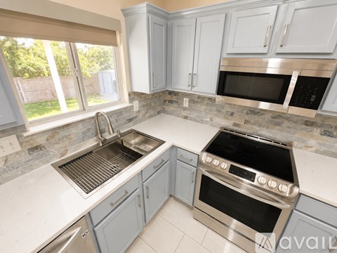 A kitchen with a stove and sink.