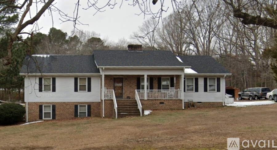 A house with a white front and a grey roof is available for sale.