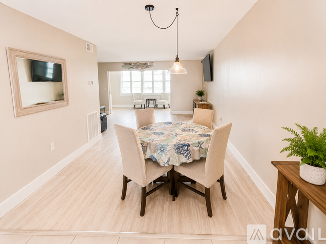 A dining room with a table set for four.