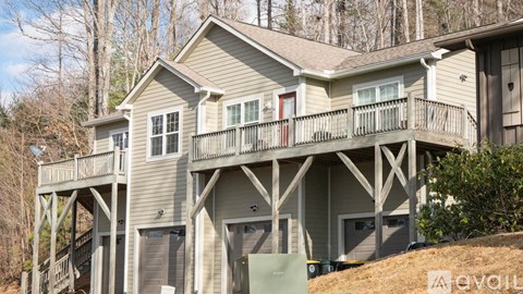 A two-story house with a balcony and a garage.