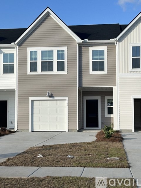 A two-story house with a garage is shown in the image.