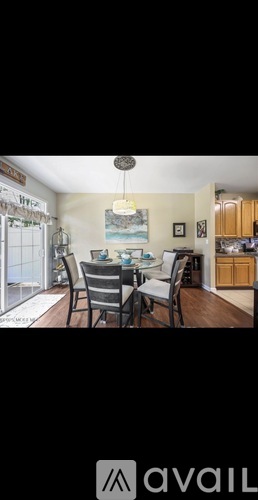 A dining room with a table set for four.