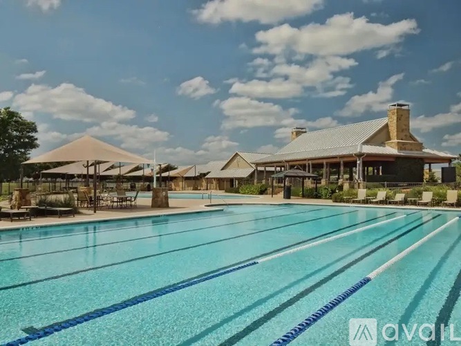 A large swimming pool with a building in the background.