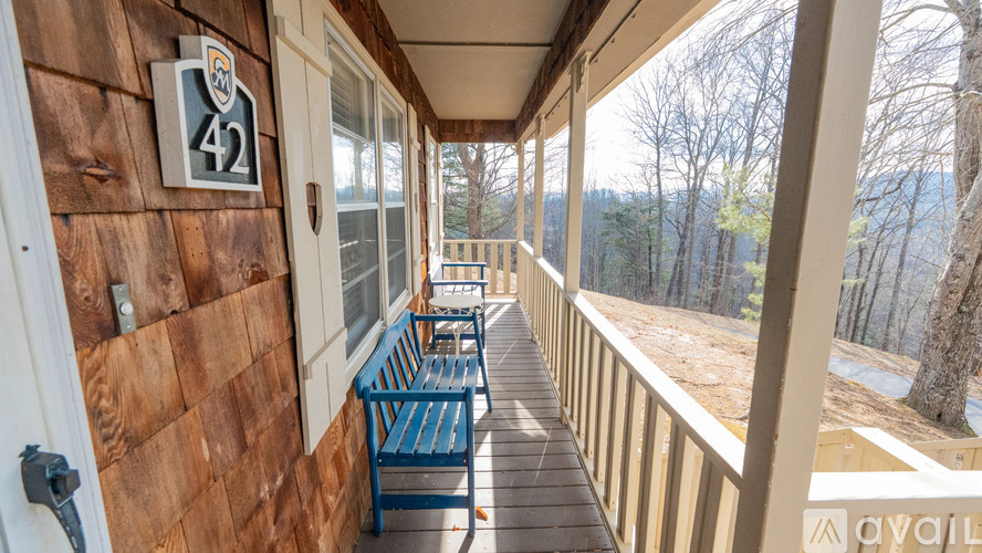 A balcony with a bench and a number 42 on the wall.