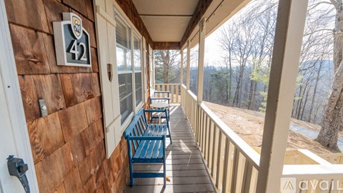 A balcony with a bench and a number 42 on the wall.