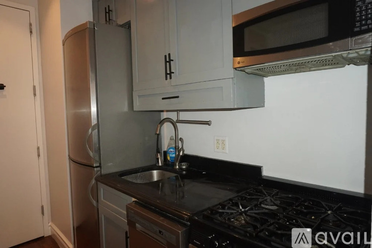 A kitchen with a black countertop and stove.