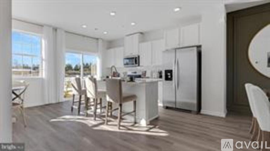 A modern kitchen with white cabinets and a large island.