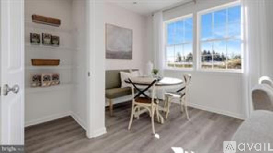 A small dining room with a table and chairs.