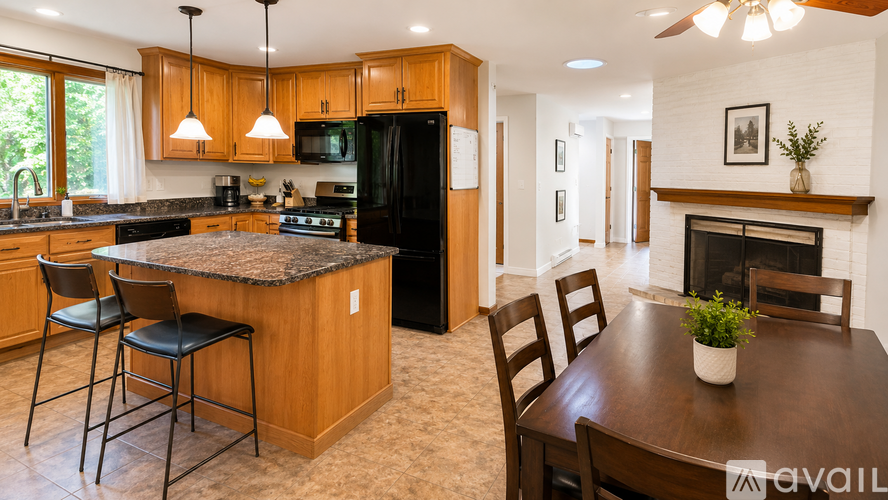 A kitchen with wooden cabinets and a black refrigerator.