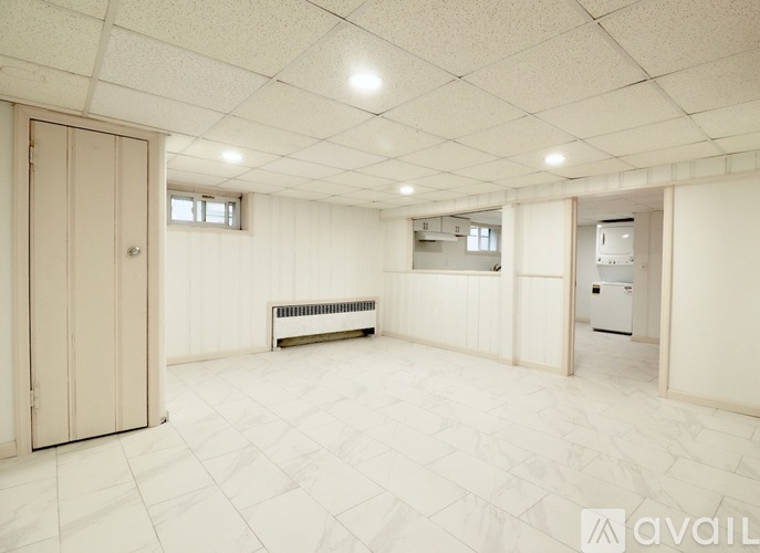 A spacious room with a radiator and a door.