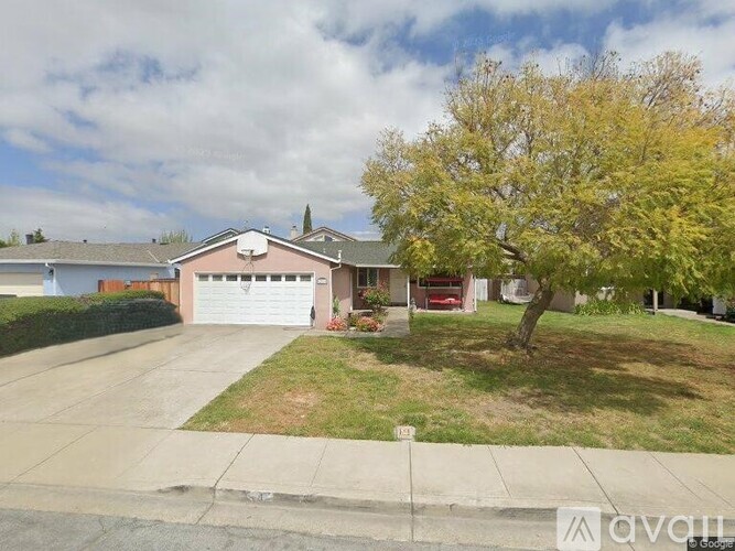 A house with a tree in front of it.