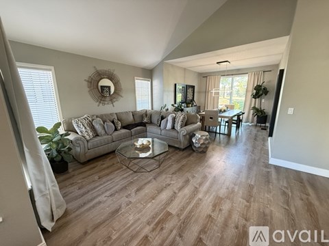 A living room with a grey sofa and a coffee table.