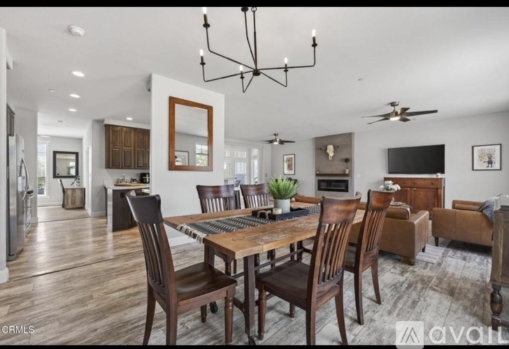 A modern dining room with a wooden table and chairs.