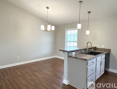 A kitchen with a sink and a window.