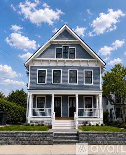 A blue house with white trim and a black door.