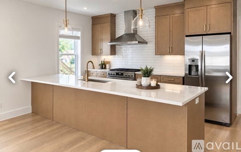 A modern kitchen with wooden cabinets and a white countertop.