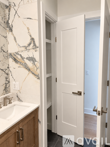 A white door is open to a hallway.