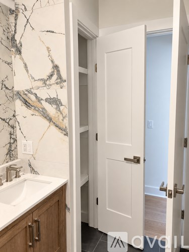 A white door is open to a hallway.