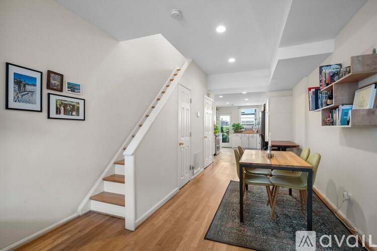A living room with a dining table and chairs.