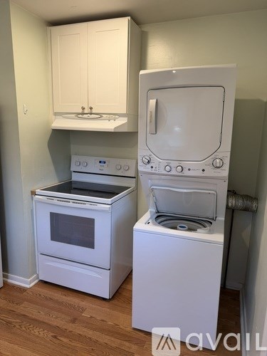 A white oven and stove top are in a kitchen.