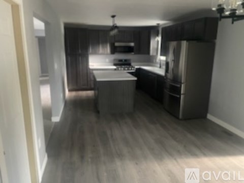 A kitchen with a refrigerator, stove, and oven.