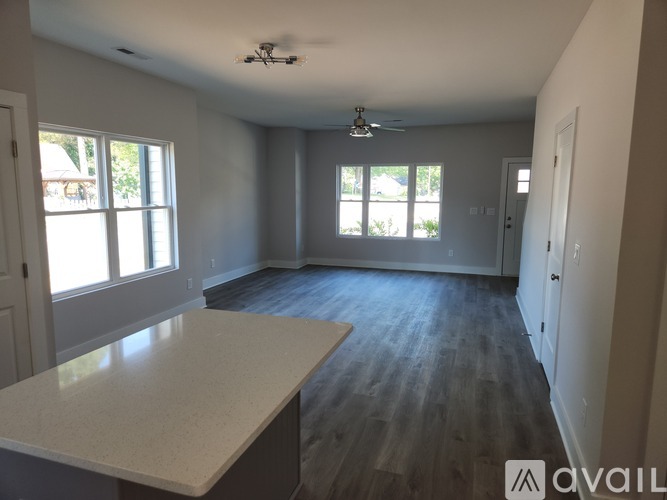 A spacious room with a large island in the middle.