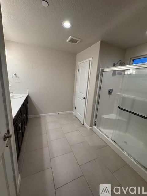 A kitchen with white cabinets and a white door.