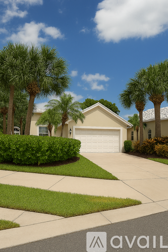 A house with a white garage door is surrounded by greenery and palm trees.