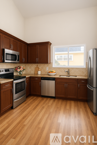 A kitchen with wooden cabinets and a stainless steel refrigerator.