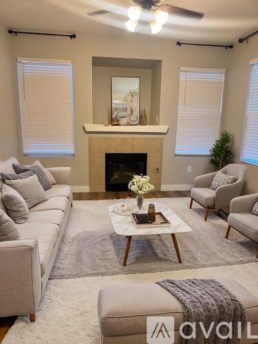 A living room with a fireplace, couches, and a coffee table.