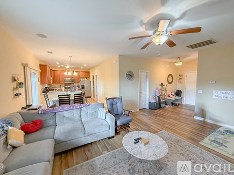 A living room with a grey couch and a white coffee table.