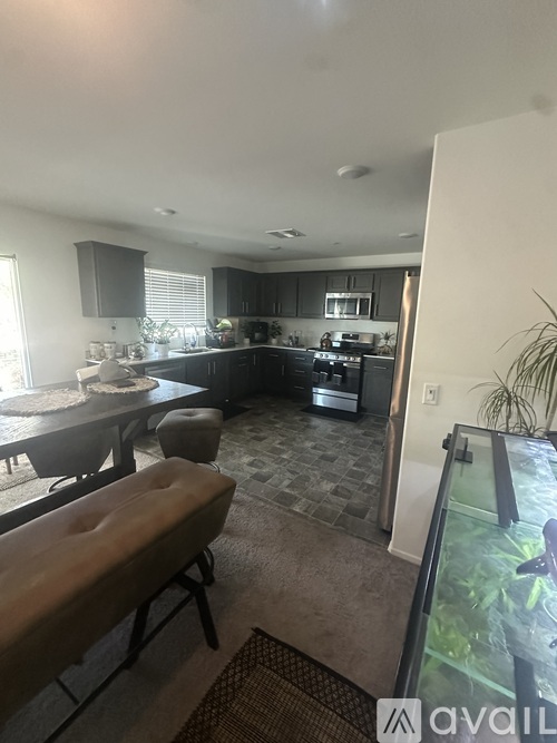 A kitchen with a dining table and chairs.