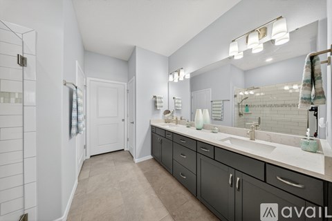 A bathroom with a large mirror and a sink.