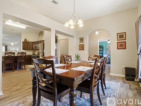 A dining room with a wooden table and chairs.