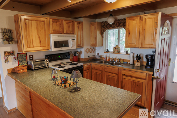 A kitchen with wooden cabinets and granite countertops.