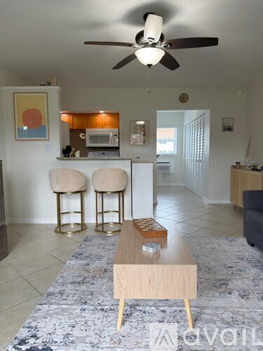 A kitchen with a white oven and microwave above it.