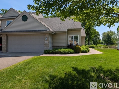 A house with a garage and a driveway is shown.