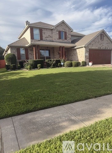 A house with a brown garage door and a driveway.