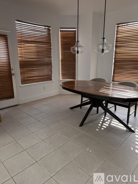 A dining room with a table and chairs.