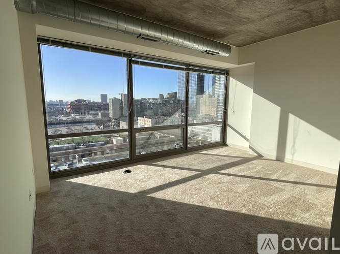 A room with a large window overlooking a cityscape.