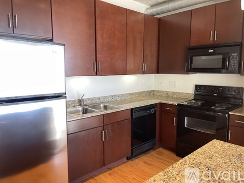 A kitchen with brown cabinets and a granite countertop.