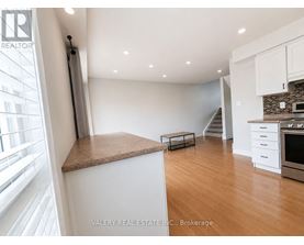 A kitchen with white cabinets and a brown countertop.