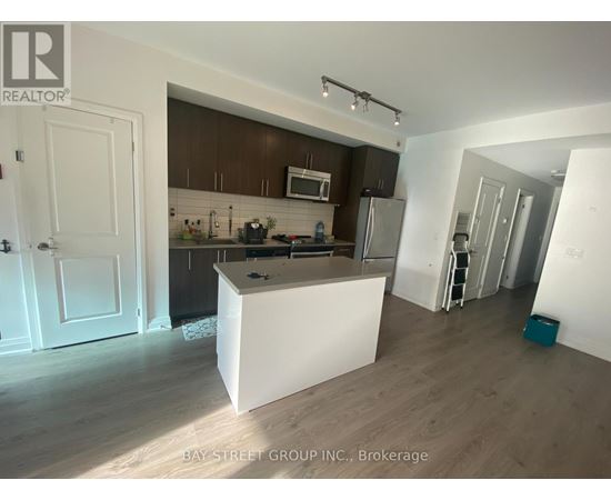 A kitchen with a white island in the middle of the room.