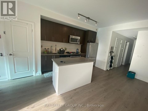 A kitchen with a white island in the middle of the room.