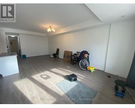 A room with a wooden floor and a bicycle in it.