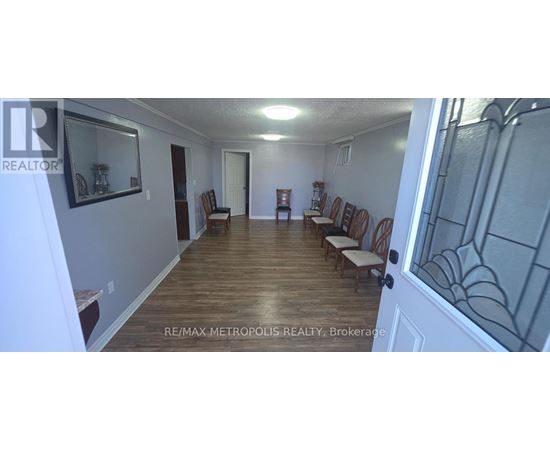 A long hallway with chairs on either side.