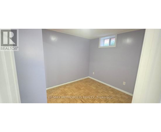 A room with a window and wooden flooring.