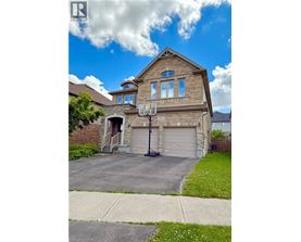 A house with a garage and a basketball hoop.