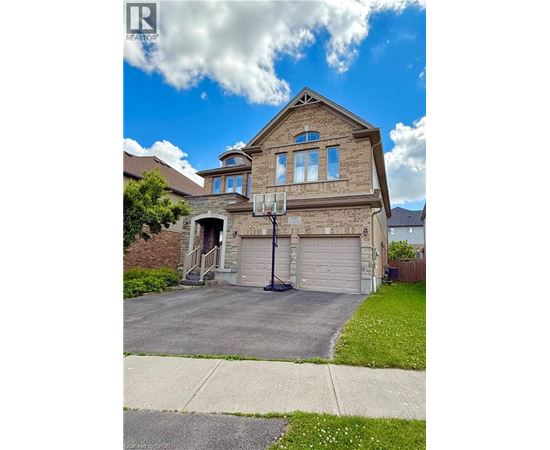 A house with a garage and a basketball hoop.